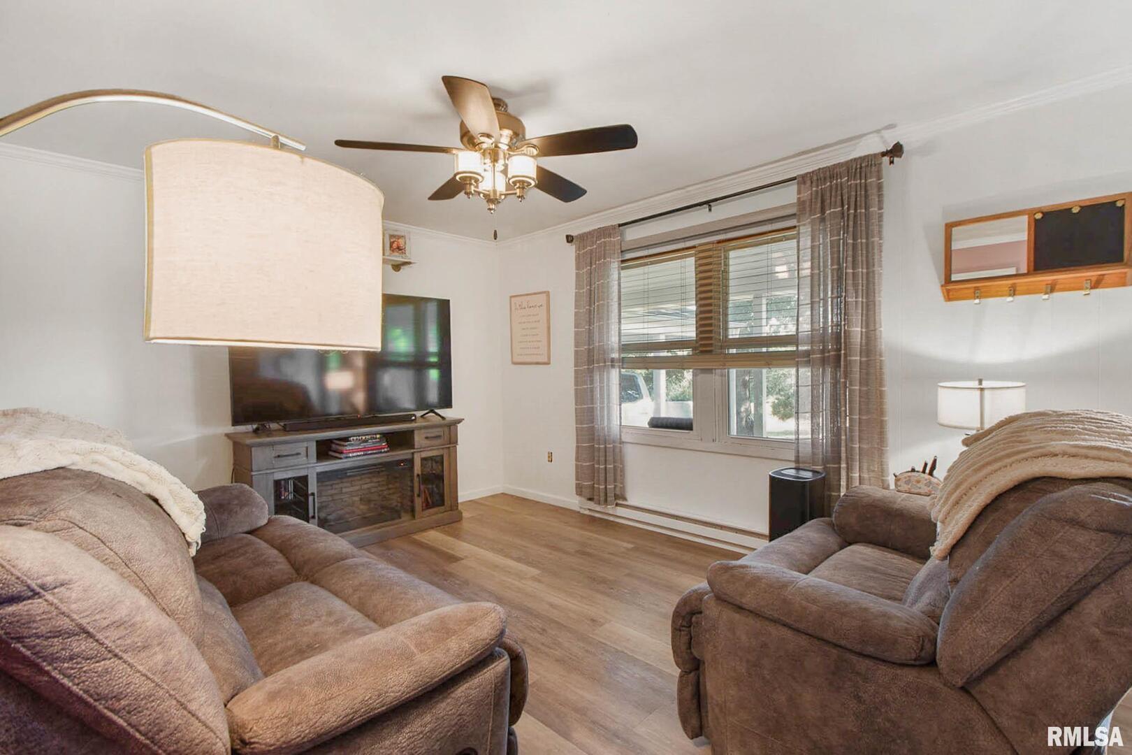 16042 Ralls Grove Road Creal Springs, IL 62922 - Photo 2 of 26 a living room with furniture a ceiling fan and a flat screen tv