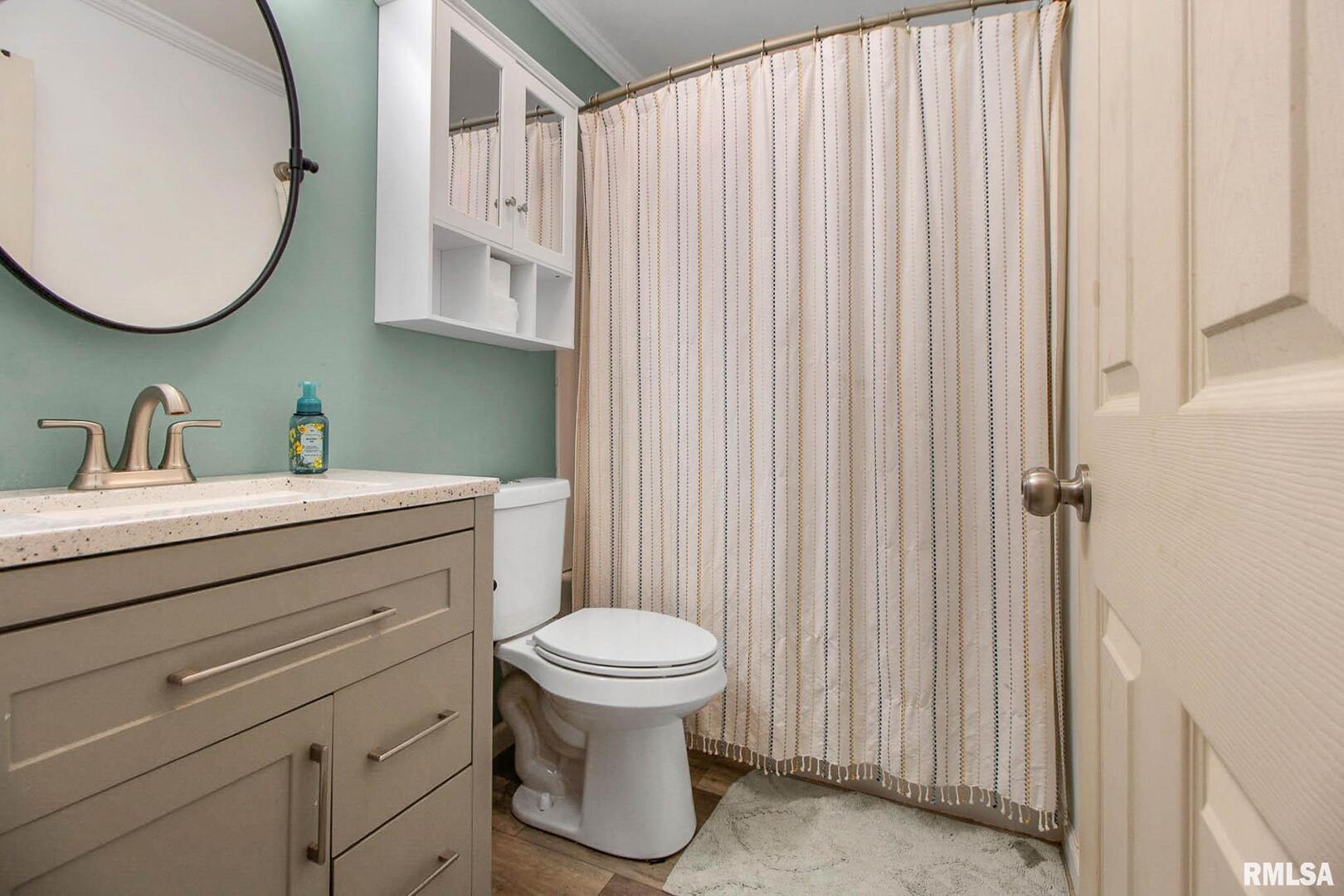 16042 Ralls Grove Road Creal Springs, IL 62922 - Photo 5 of 26 a bathroom with a toilet a sink and mirror