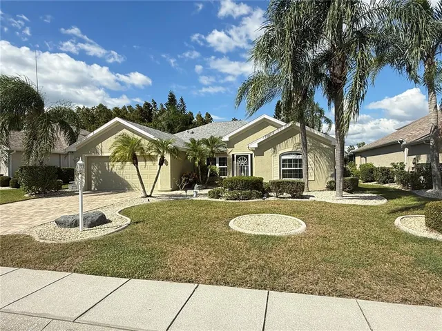 a front view of a house with yard and green space