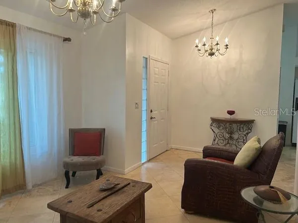 a kitchen with a sink a counter and chairs