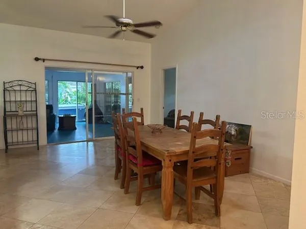 a view of a dining room with furniture and chandelier