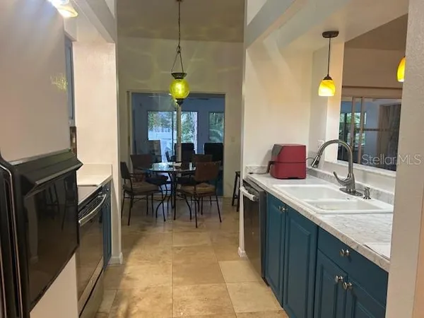 a kitchen with a sink appliances and cabinets