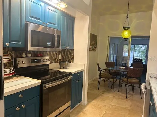 a view of kitchen with furniture and chandelier