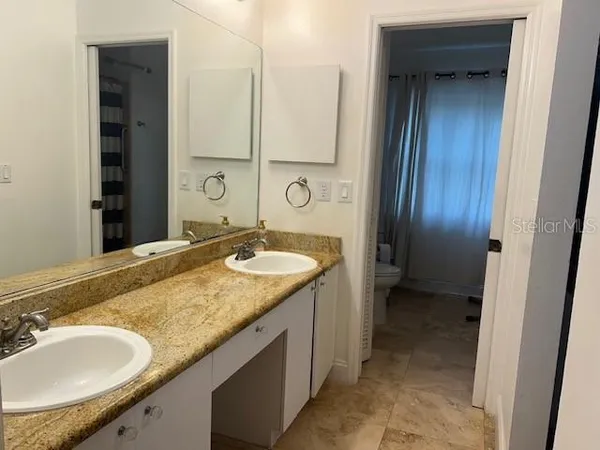 a bathroom with a shower and a sink