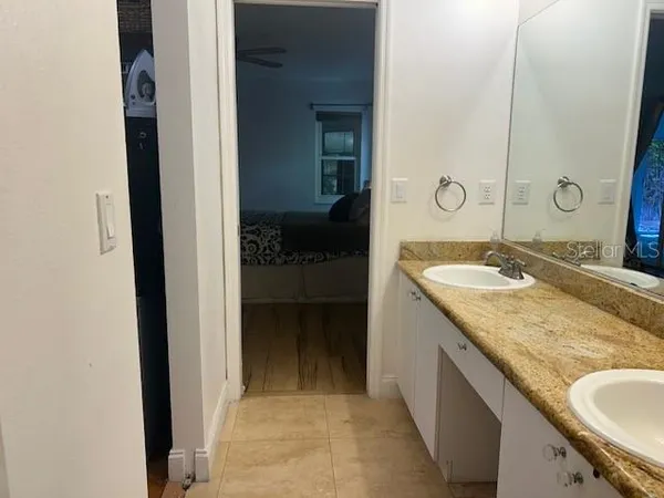 a view of a room with wooden floor and a bathroom