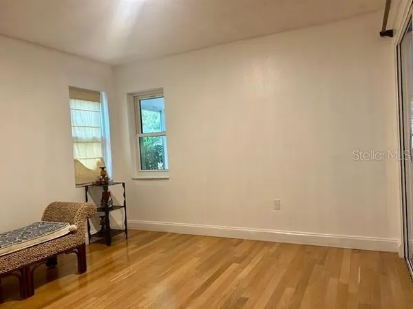 a view of room with wooden floor