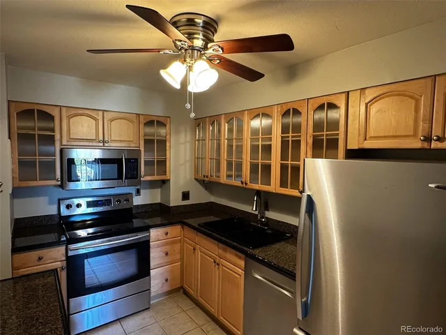 a kitchen with stainless steel appliances granite countertop a stove and a microwave