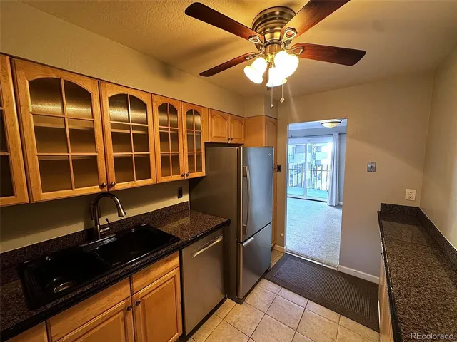 a kitchen with a refrigerator and a sink
