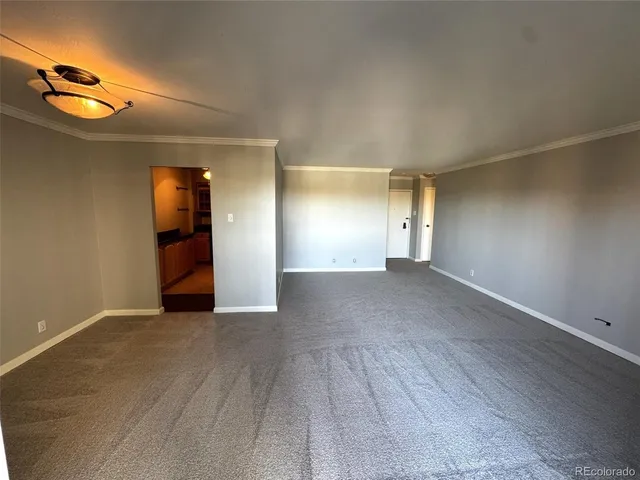 an empty room with a empty space and a ceiling fan