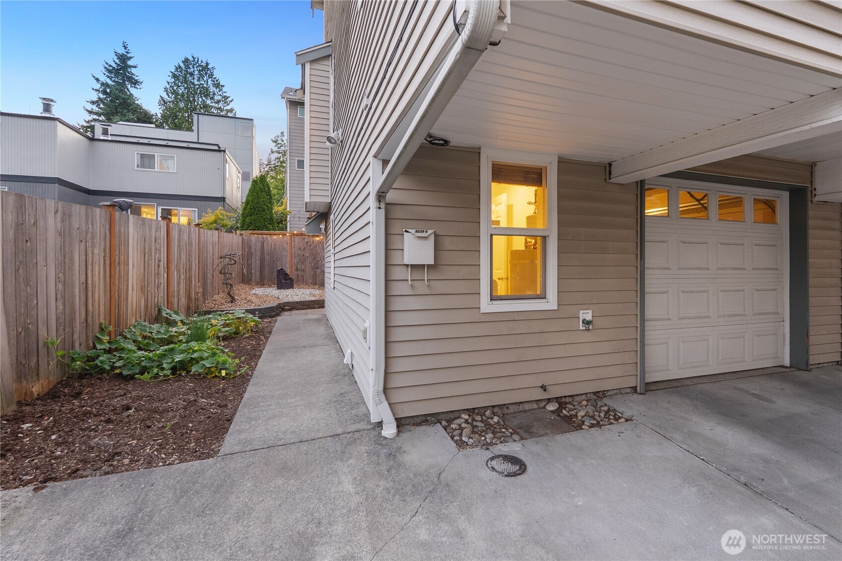 9239 Ashworth Avenue North, Unit B Seattle, WA 98103 - Photo 30 of 40 a view of a house with backyard and wooden fence