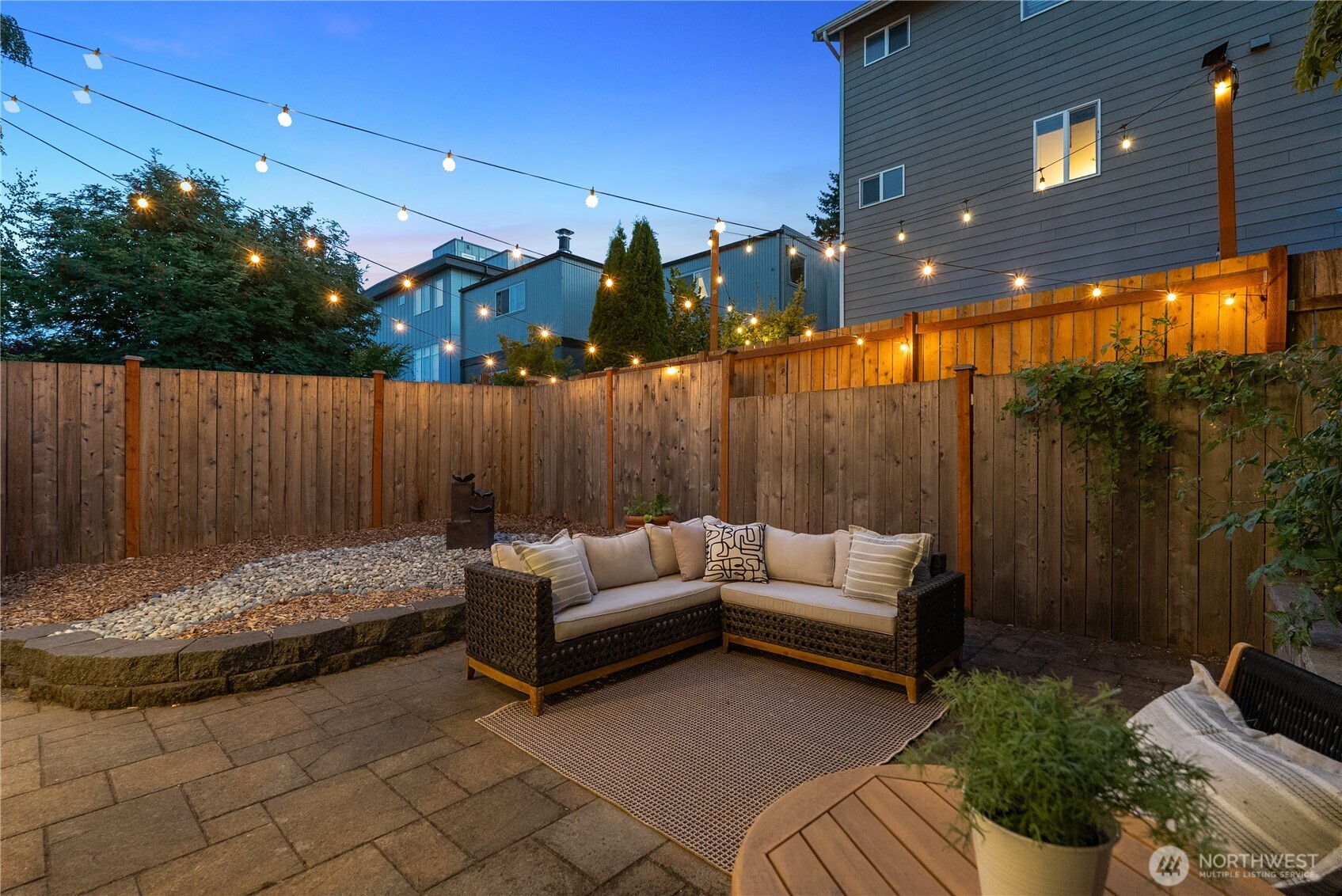 9239 Ashworth Avenue North, Unit B Seattle, WA 98103 - Photo 32 of 40 a outdoor living space with furniture and a fireplace