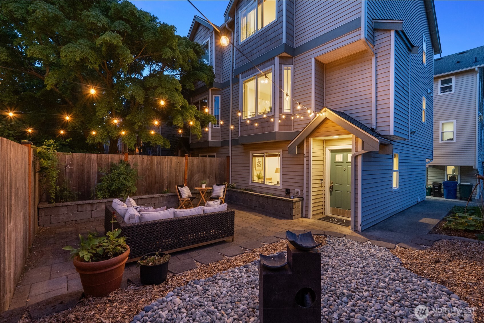 9239 Ashworth Avenue North, Unit B Seattle, WA 98103 - Photo 36 of 40 a patio with patio a couch and potted plants