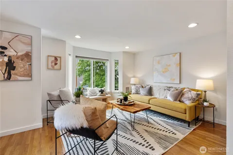 a living room with furniture and wooden floor