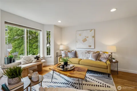 a living room with furniture and wooden floor