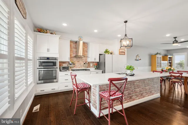 a large kitchen with a table and chairs