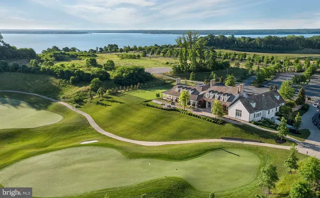 a view of a swimming pool with outdoor seating and lake