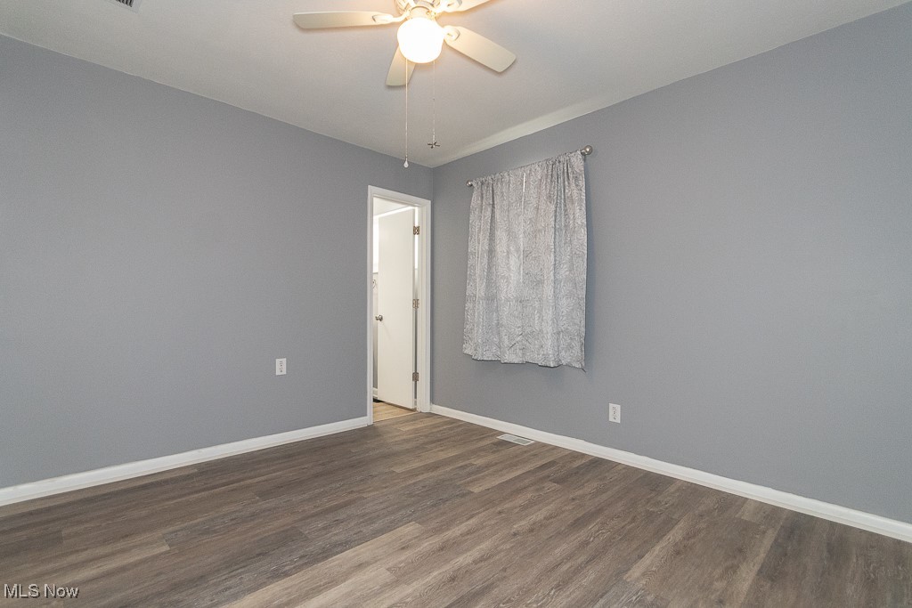7996 Munson Road Mentor, OH 44060 - Photo 14 of 33 Unfurnished room with ceiling fan and dark hardwood / wood-style floors