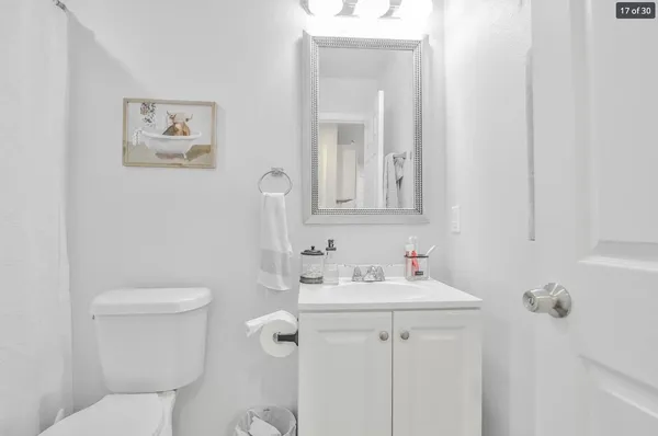 a bathroom with a toilet sink and mirror
