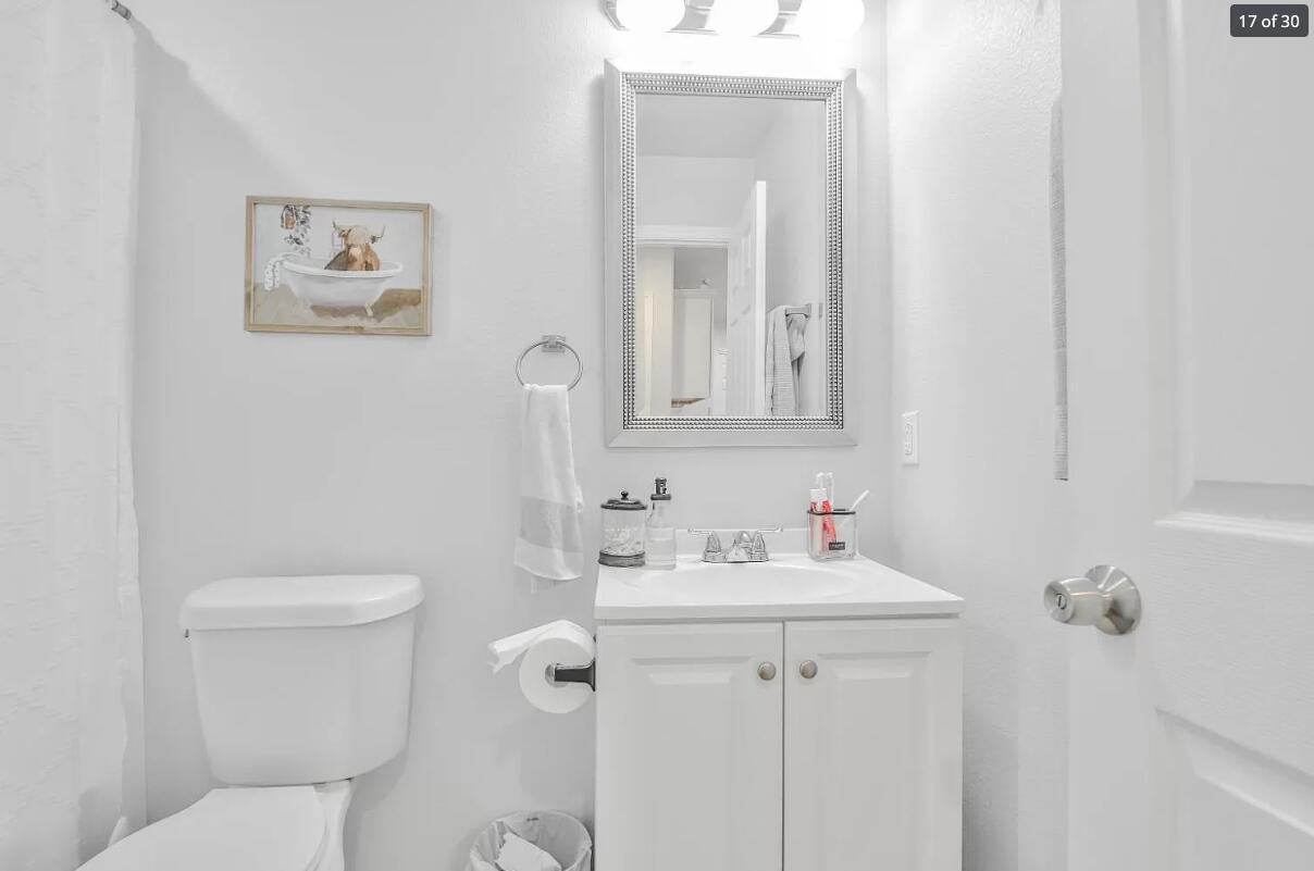 5502 Jarvis Street Lubbock, TX 79416 - Photo 11 of 13 a bathroom with a toilet sink and mirror