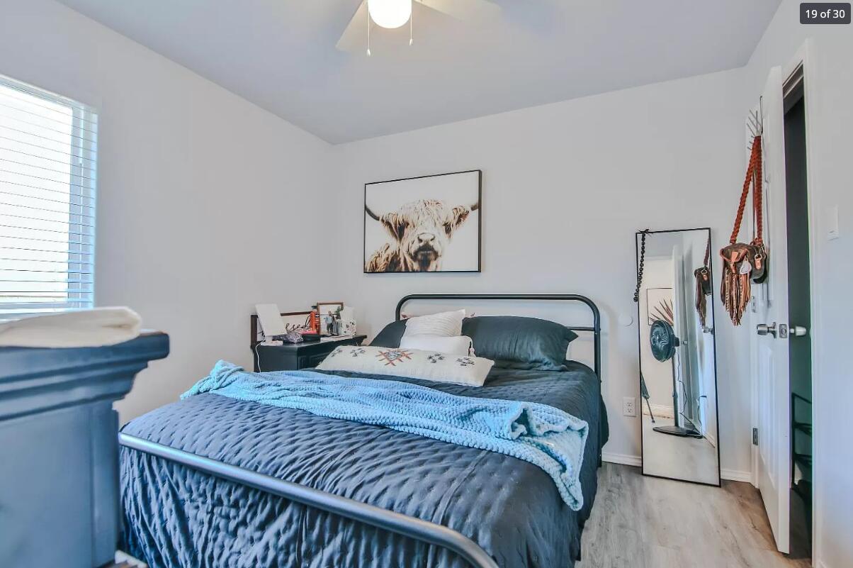 5502 Jarvis Street Lubbock, TX 79416 - Photo 12 of 13 a bedroom with a bed and a window