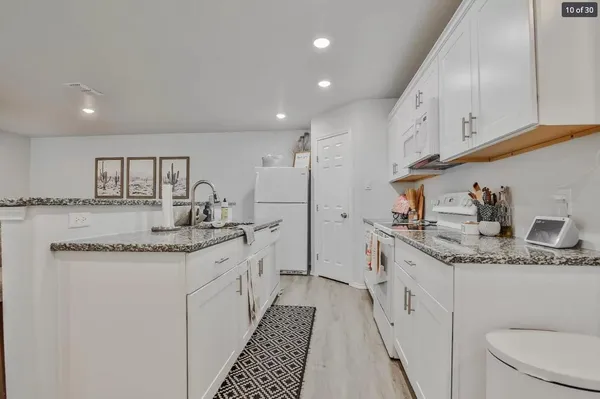 a kitchen with a sink stove and cabinets