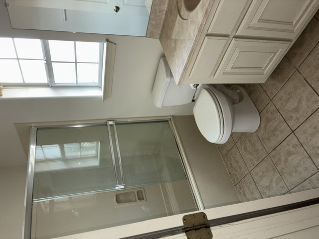 404 West 24th Street Bryan, TX 77803 - Photo 21 of 22 a bathroom with a toilet sink and shower