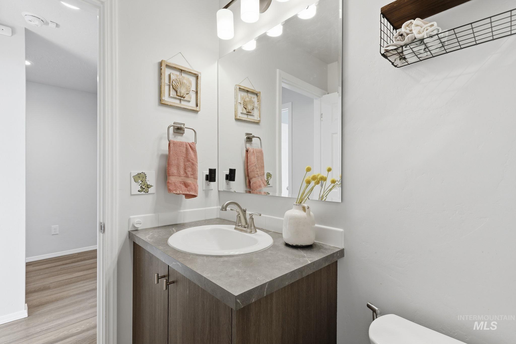 16780 Breton Way Caldwell, ID 83607 - Photo 6 of 28 Bathroom vanity featuring a single basin sink, brushed nickel faucet, and a grey patterned countertop