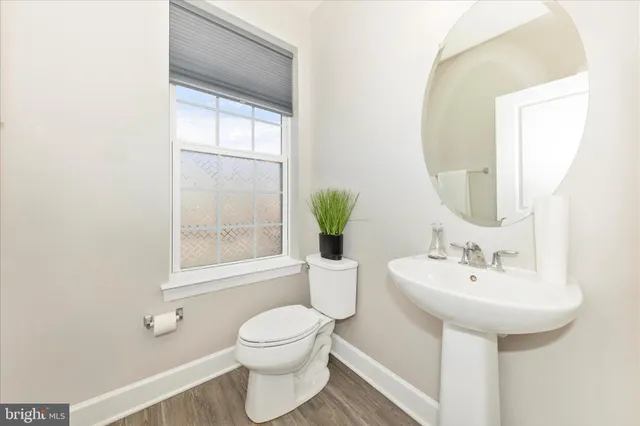 a bathroom with a sink toilet and mirror