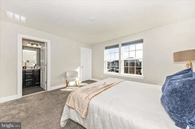 a spacious bedroom with a bed and wooden floor