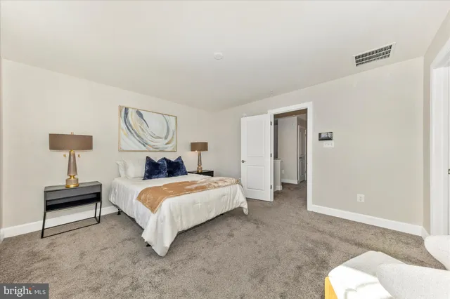 a bedroom with a bed and a lamp