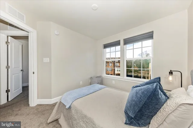 a spacious bedroom with a bed and a large window