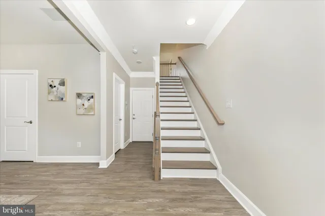 a view of entryway and hall with wooden floor