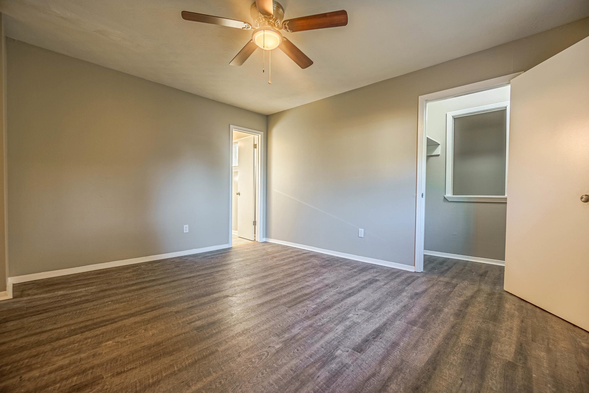 1223 Aubra Road Memphis, TN 38111 - Photo 12 of 19 an empty room with wooden floor closet and windows