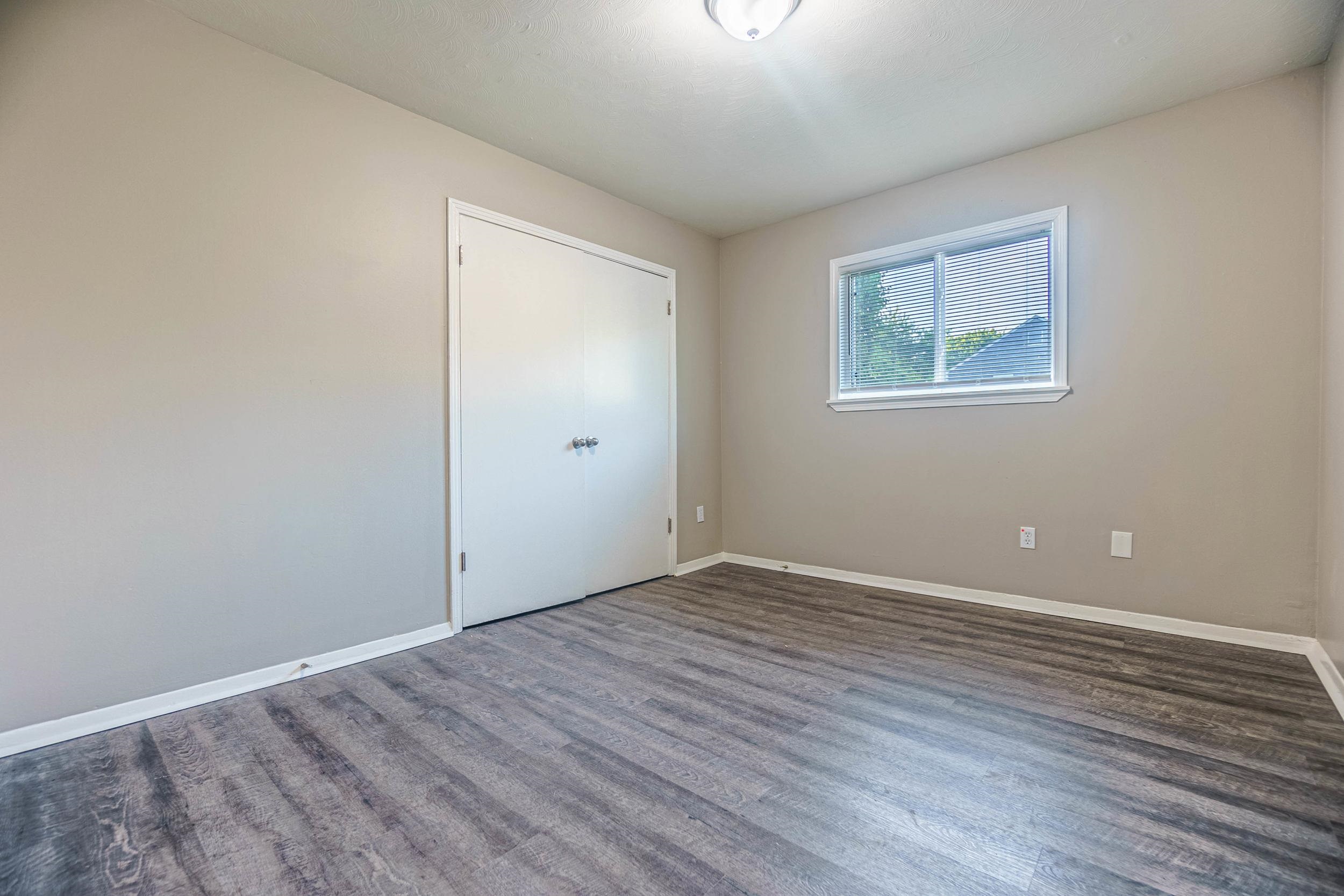 1223 Aubra Road Memphis, TN 38111 - Photo 17 of 19 an empty room with wooden floor and windows