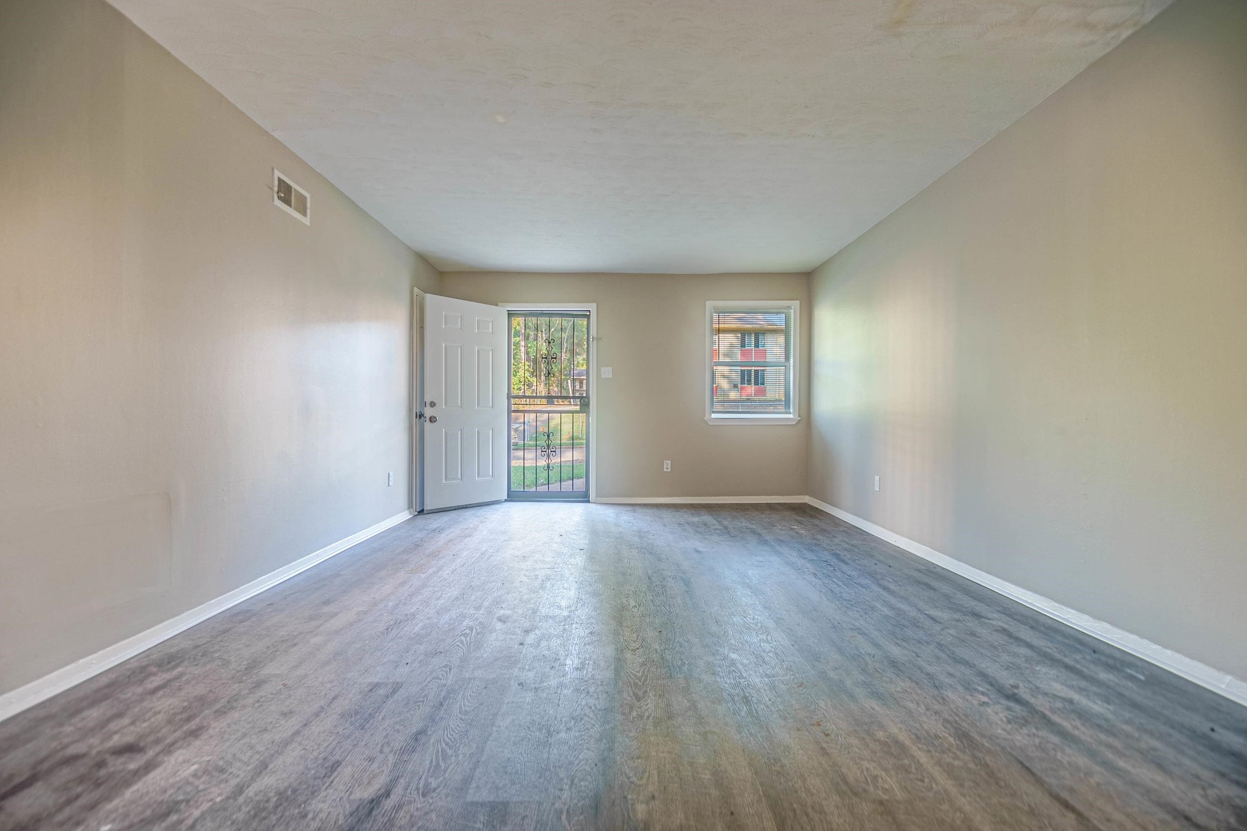 1223 Aubra Road Memphis, TN 38111 - Photo 3 of 19 an empty room with wooden floor and windows