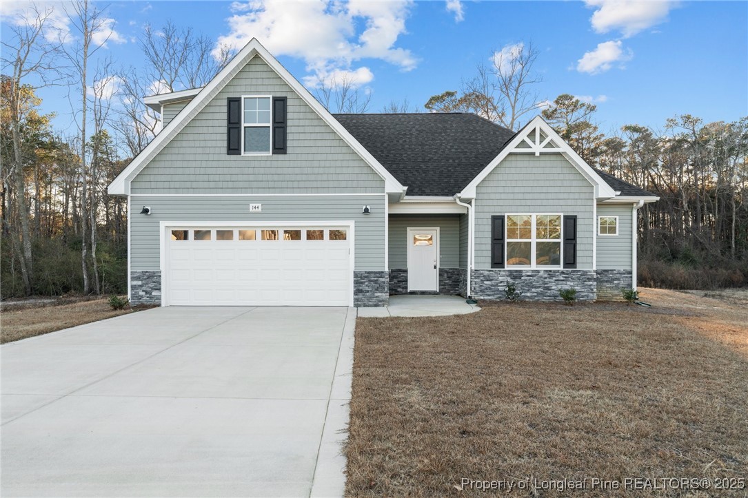 a view of house with yard and a garage