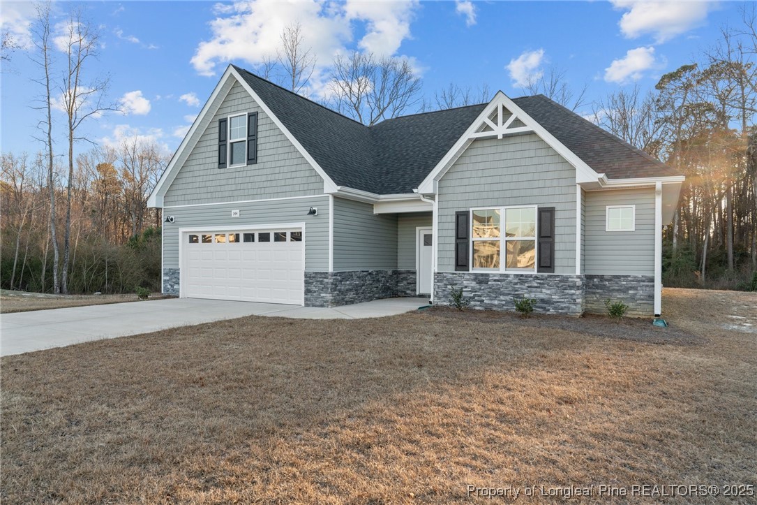 144 Vorster Road Raeford, NC 28376 - Photo 2 of 35 a view of a yard in front of a house with large trees