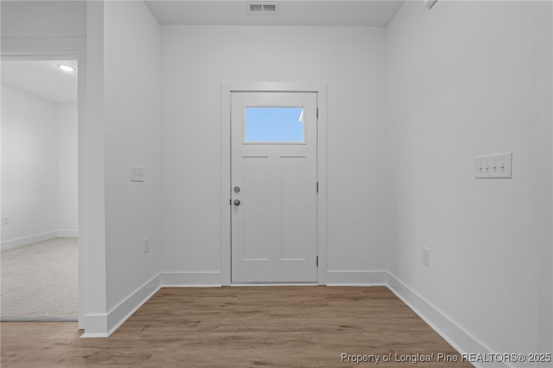 144 Vorster Road Raeford, NC 28376 - Photo 5 of 35 a view of an empty room with wooden floor