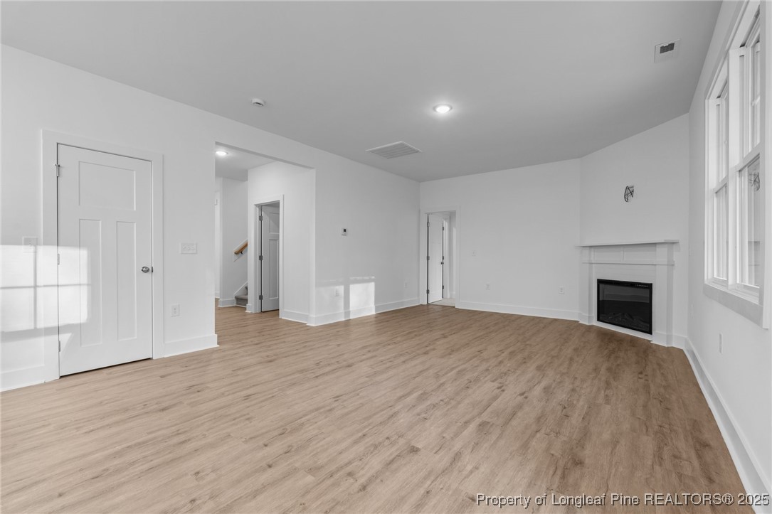 144 Vorster Road Raeford, NC 28376 - Photo 6 of 35 a view of empty room with wooden floor and fireplace