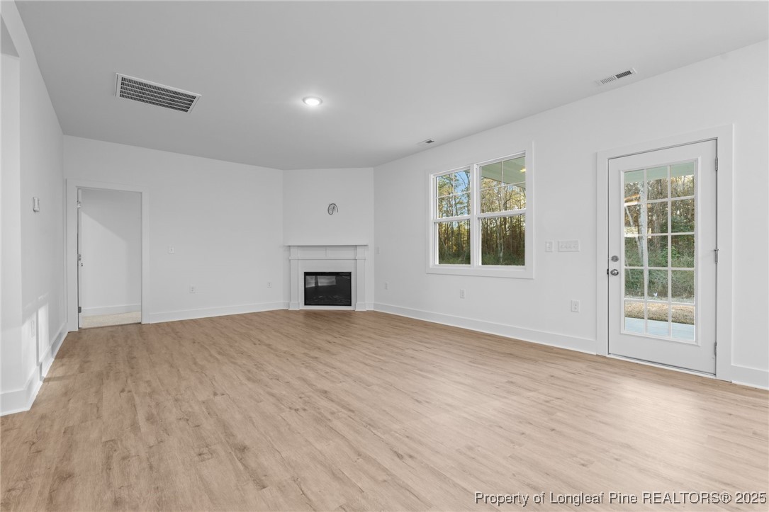144 Vorster Road Raeford, NC 28376 - Photo 7 of 35 a view of an empty room with a window and fireplace