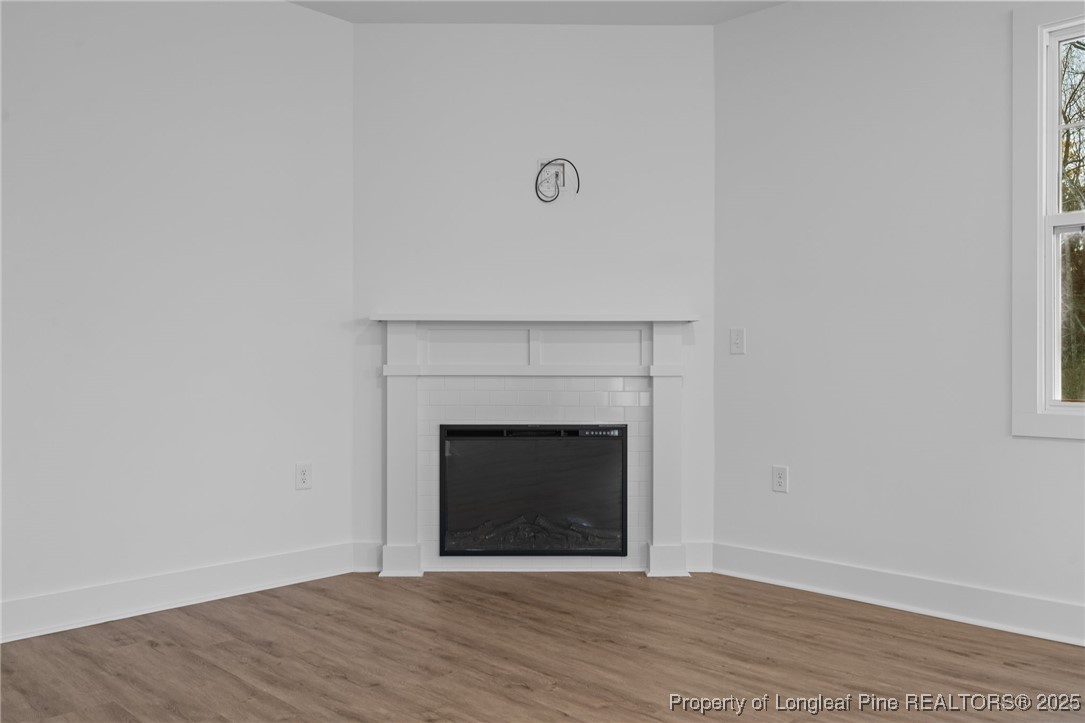 144 Vorster Road Raeford, NC 28376 - Photo 8 of 35 a view of an empty room with wooden floor and a fireplace
