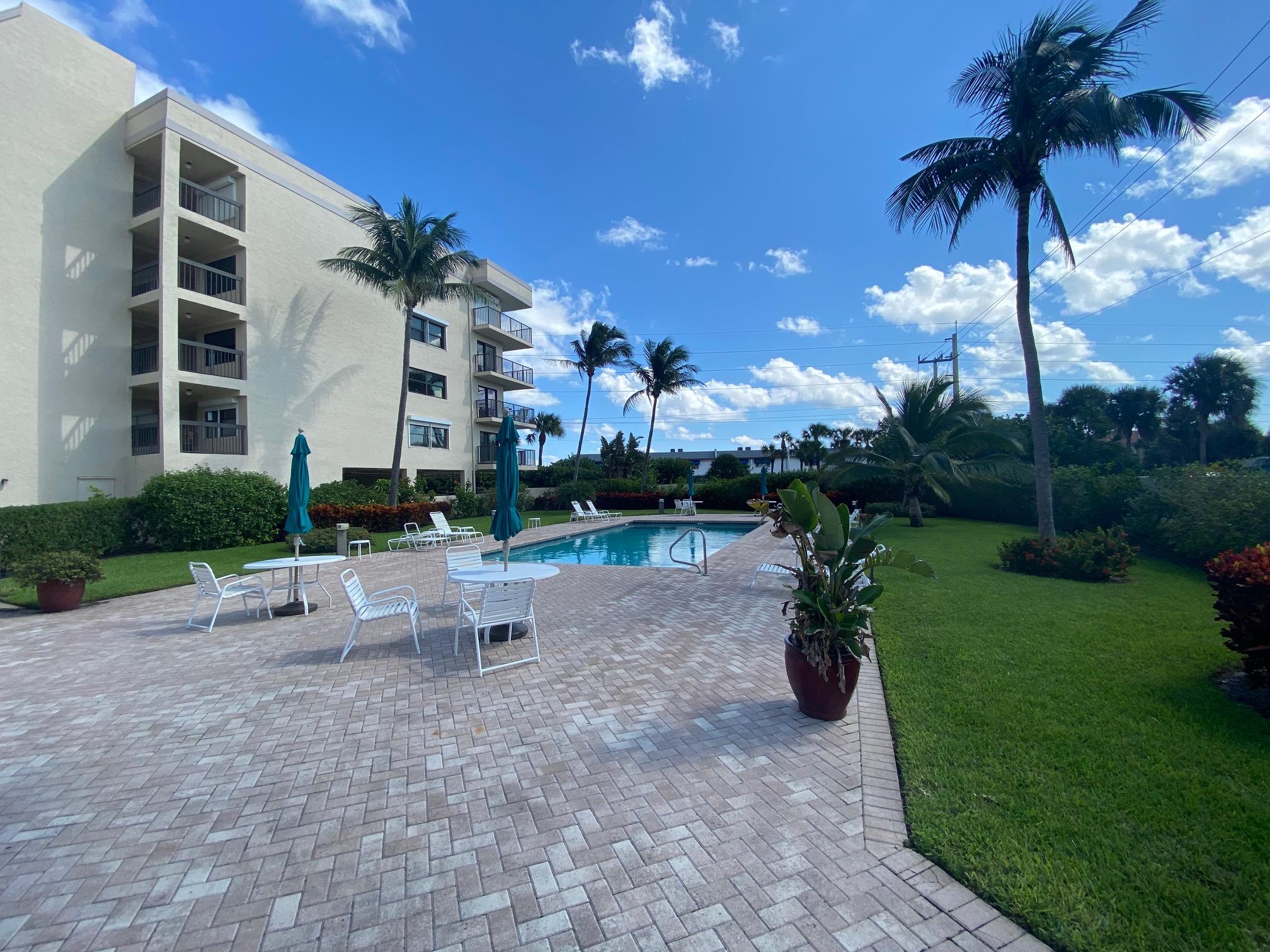 1055 Ocean Drive, Unit 403 Juno Beach, FL 33408 - Photo 11 of 28 a view of a patio with a table and chairs