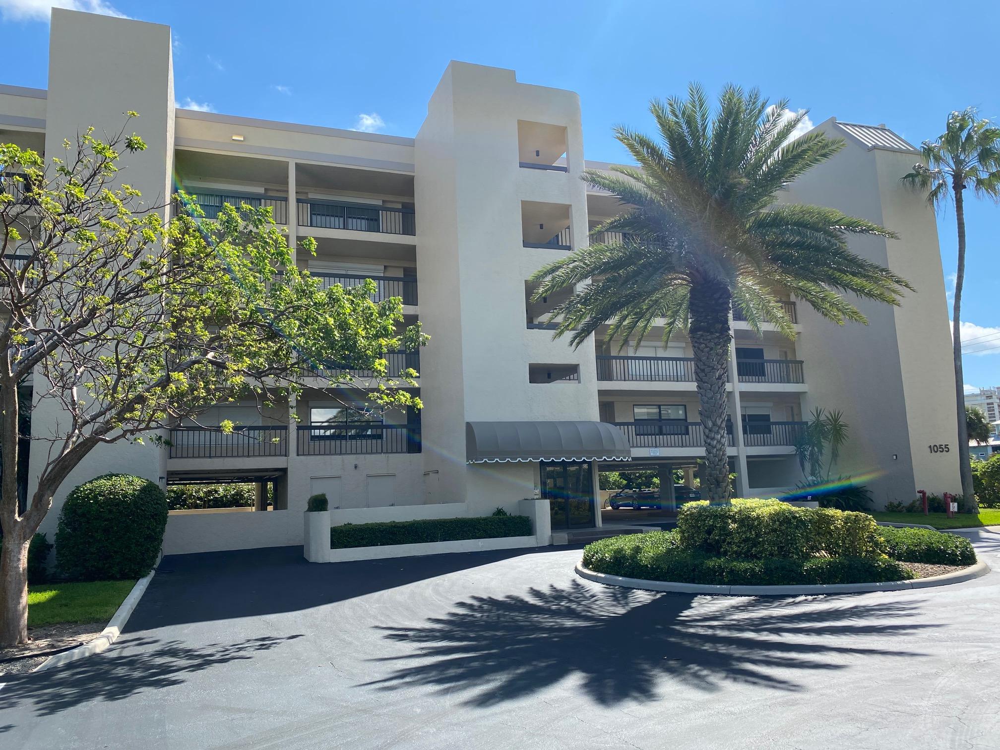 1055 Ocean Drive, Unit 403 Juno Beach, FL 33408 - Photo 21 of 28 a front view of a house with garden and parking