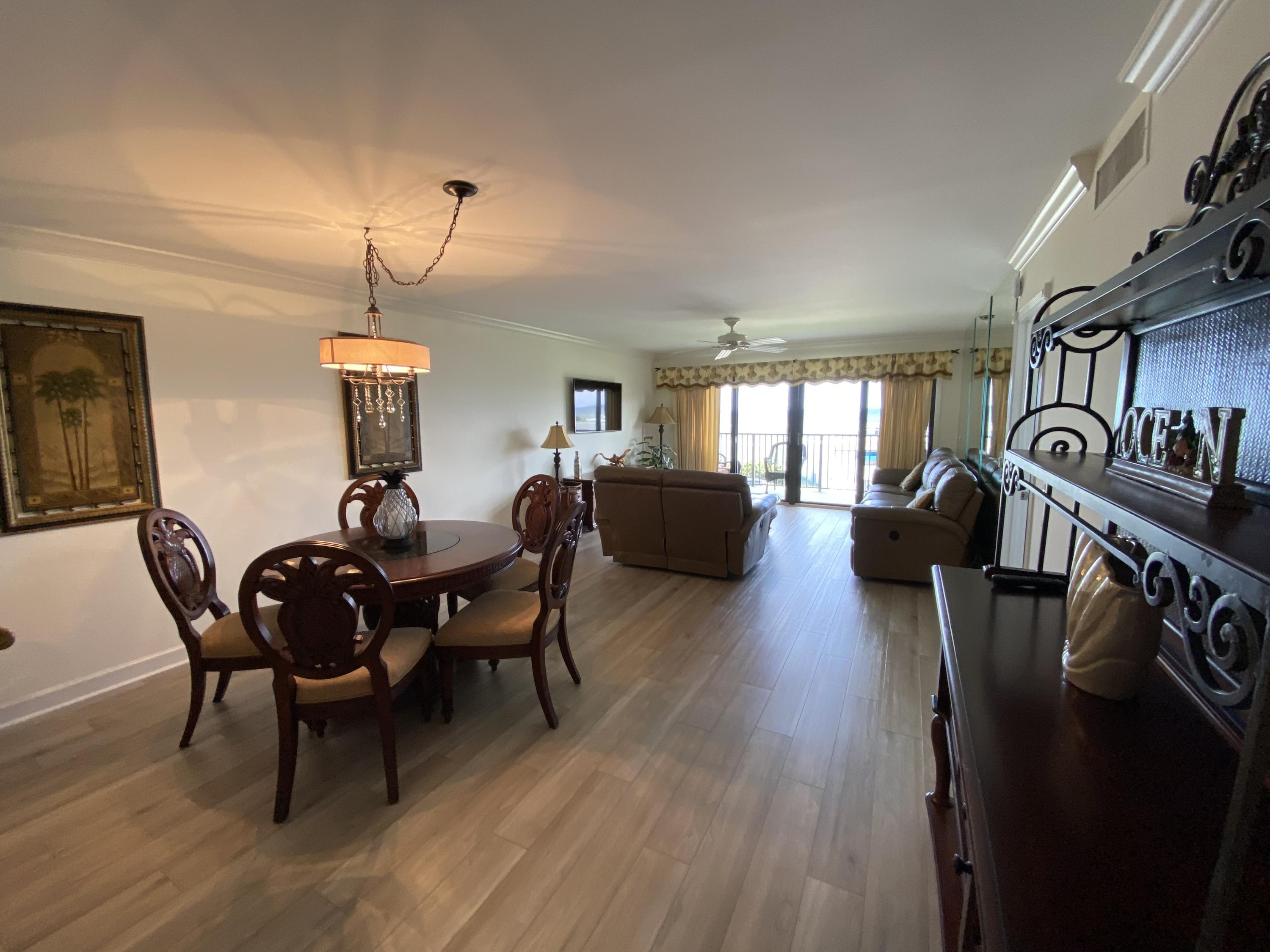 1055 Ocean Drive, Unit 403 Juno Beach, FL 33408 - Photo 5 of 28 a living room with furniture dining table and wooden floor