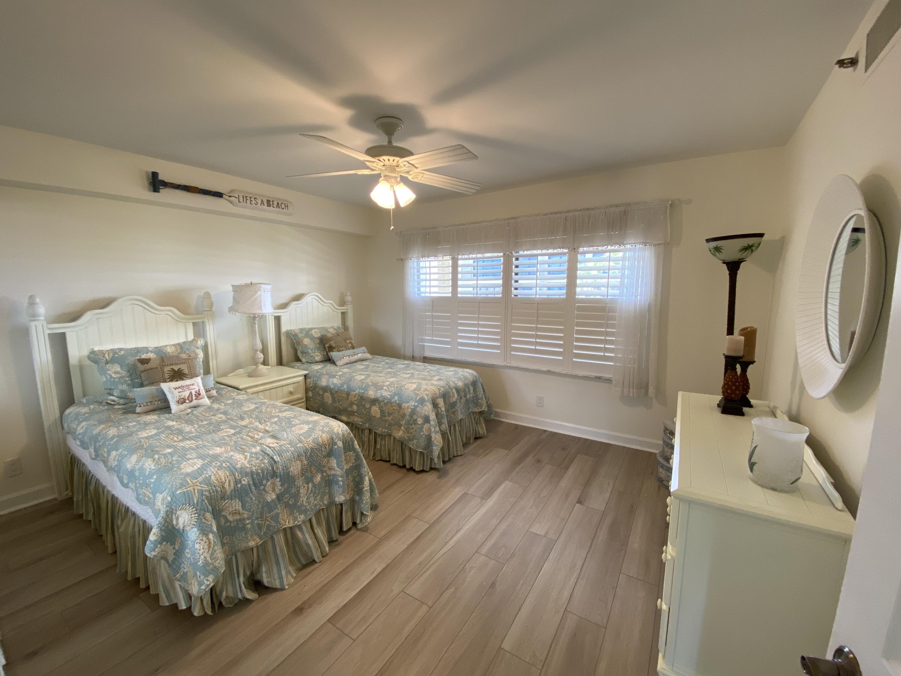 1055 Ocean Drive, Unit 403 Juno Beach, FL 33408 - Photo 9 of 28 a bedroom with double bed and a window