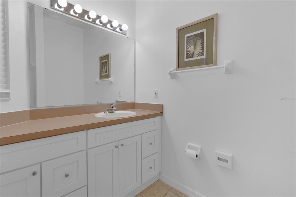 1070 Park Ridge Circle Kissimmee, FL 34746 - Photo 17 of 36 a bathroom with a sink and a mirror