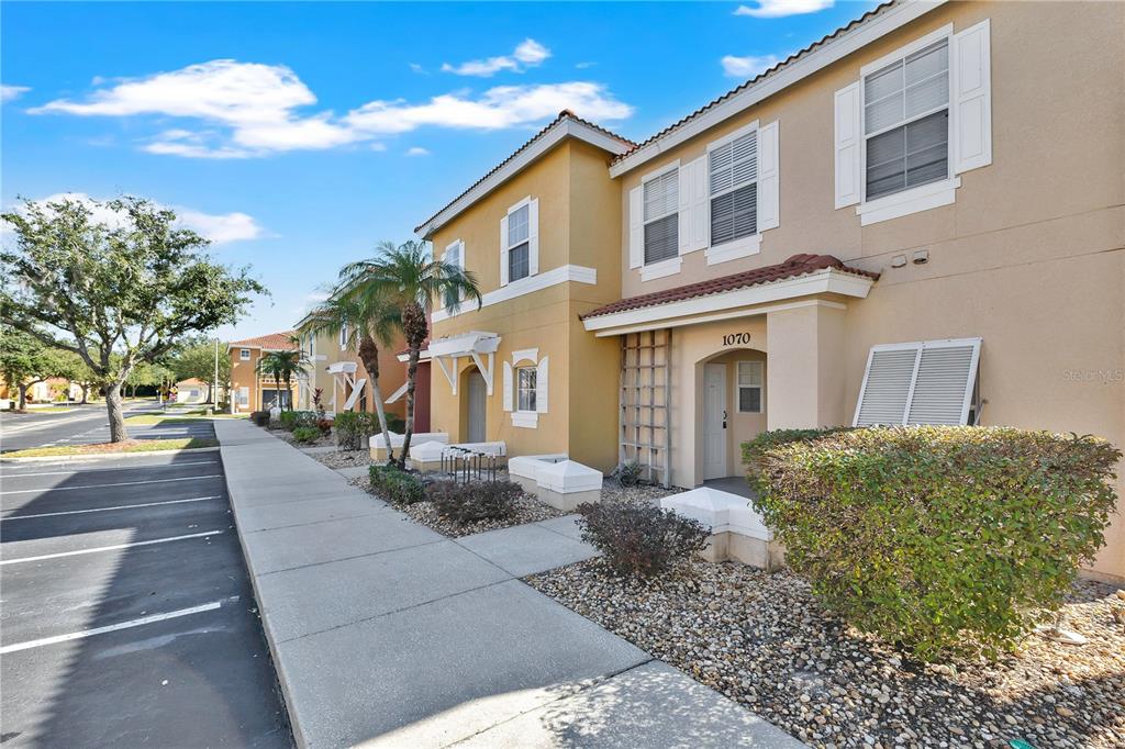 1070 Park Ridge Circle Kissimmee, FL 34746 - Photo 2 of 36 a front view of a house with a yard
