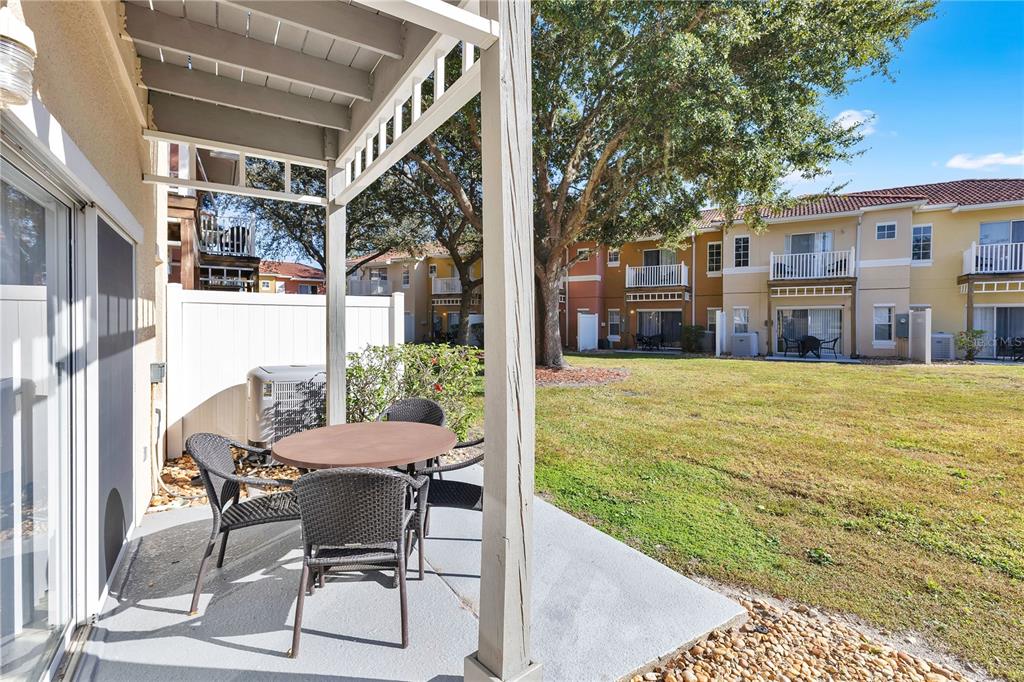 1070 Park Ridge Circle Kissimmee, FL 34746 - Photo 22 of 36 a view of a patio with table and chairs and potted plants