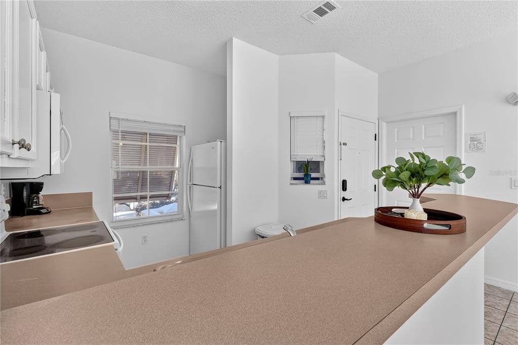 1070 Park Ridge Circle Kissimmee, FL 34746 - Photo 5 of 36 a kitchen with a sink a stove and white cabinets