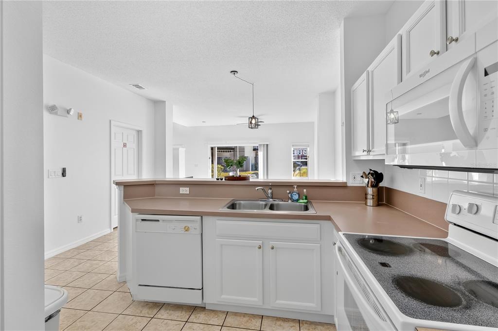 1070 Park Ridge Circle Kissimmee, FL 34746 - Photo 8 of 36 a kitchen with a sink stove and cabinets